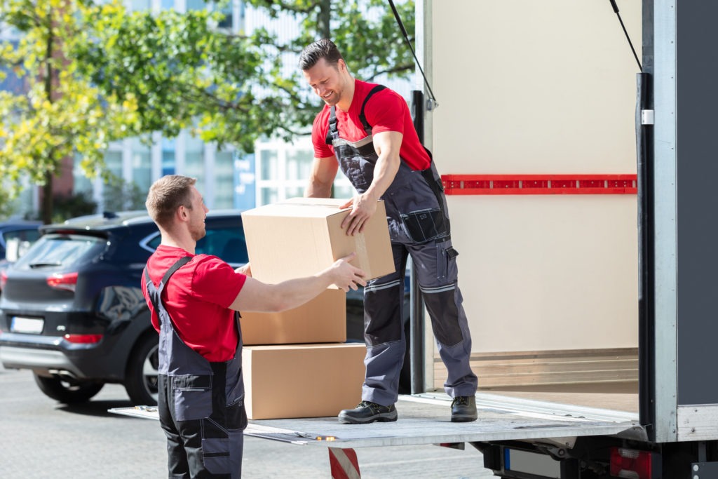 Two guys loading in a truck